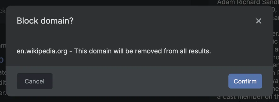 A dialog titled Block domain? reading en.wikipedia.org - This domain will be removed from all results, with Cancel and Confirm buttons.