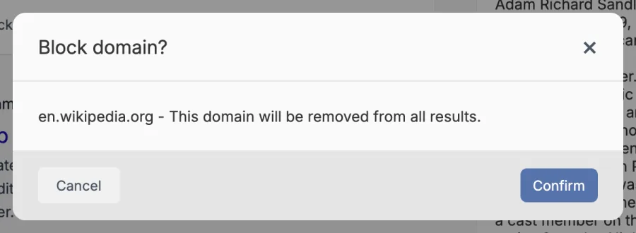 A dialog titled Block domain? reading en.wikipedia.org - This domain will be removed from all results, with Cancel and Confirm buttons.